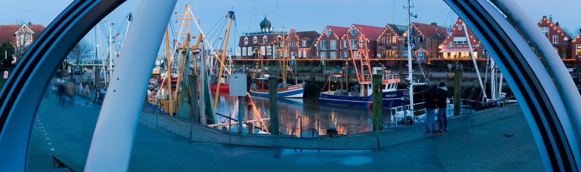 Neuharlingersiel,Germany - January 1,2014: Panoramic view of the port of Neuharlingersiel in the evening-dawn