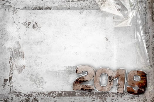 2019 Happy New Year grunge background with grungy frame and remains of scotch tape and cellophane. Fully editable. Ideal to use for parties invitation, dinner invitation, grungy events and more.