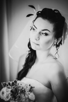 Black white photography beautiful young happy bride standing near the window