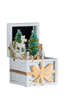 Christmas decorations background. Old wooden music box with a christmas song. The Christmas tree and the figures are moving. Christmas tree music box.