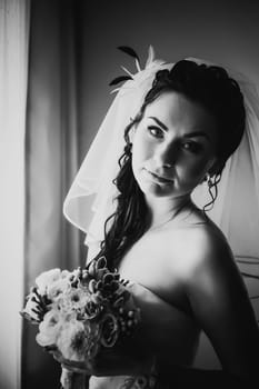 Black white photography beautiful young happy bride standing near the window