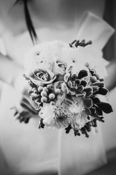 Black white photography beautiful wedding bouquet of flowers in hands the bride