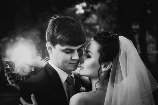 Black white photography wedding beautiful young couple stand on background forest