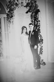 Black white photography bride and groom posing in a hotel room