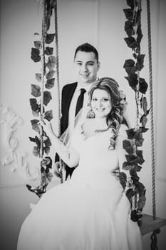 Black white photography bride and groom posing in a hotel room