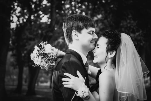 Black white photography wedding beautiful young couple stand on background forest