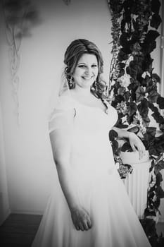 Black white photography elegance cute bride is posing on the background room