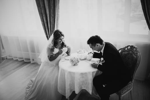 Black white photography bride and groom posing in a hotel room