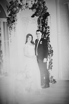 Black white photography bride and groom posing in a hotel room