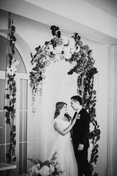 Black white photography bride and groom posing in a hotel room