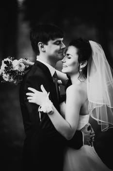 Black white photography wedding beautiful young couple stand on background forest