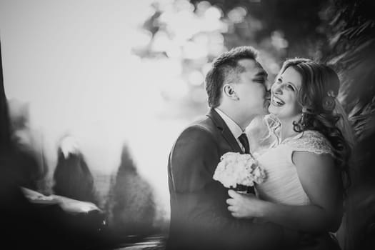 Black white photography happy couple bride and groom embracing they stand on background nature close-up
