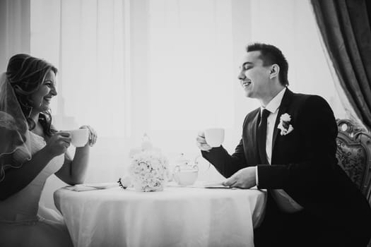Black white photography bride and groom posing in a hotel room