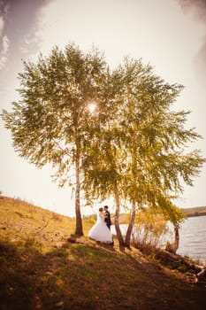young bride and groom on the background of the lake