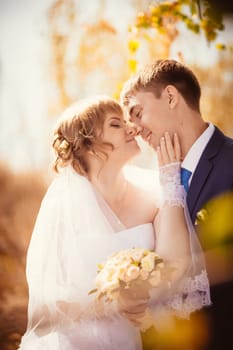 young bride and groom on the bluer background
