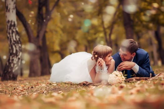 young bride and groom on the background of the autumn landscape