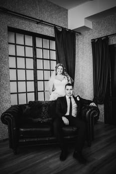 Black white photography bride and groom posing in a hotel room