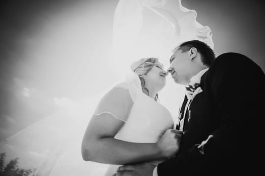 Black white photography happy couple bride and groom embracing they stand on background nature close-up
