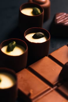 Many chocolate sweets with Pistachio on black background