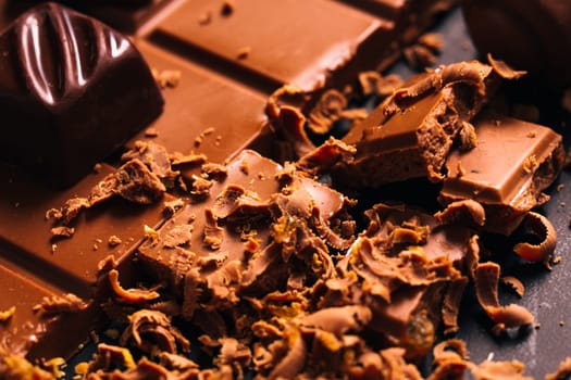 Many candy and chocolate chips on a black background