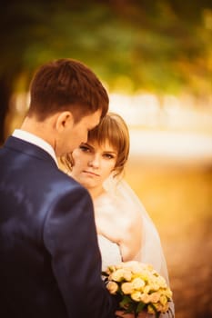 young bride and groom on the bluer background