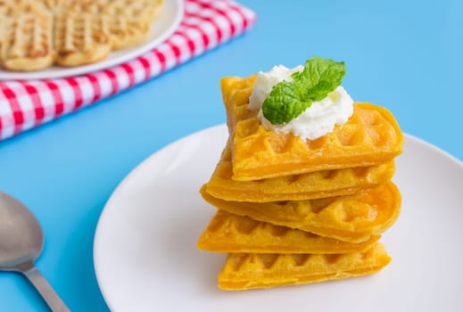 5 Pieces Heart Shape Waffle and Peppermint on Blue Pastel Background Right. Heart shape waffle dessert for food and dessert category