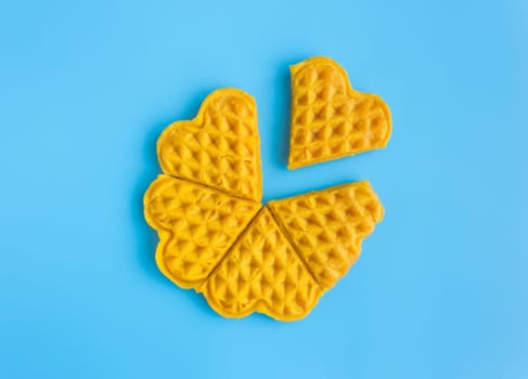5 Pieces Heart Shape Waffle in Circle on Blue Pastel Background Minimalist Style. Heart shape waffle dessert in minimalist style for food and dessert category