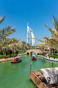 Dubai, UAE - Oct 15, 2018: Boat cruising along the waterway near Burj Al Arab