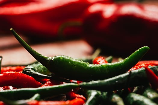 red and green chili peppers close up on wooden background