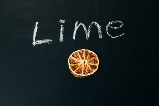 one sliced orange circle on a black background board
