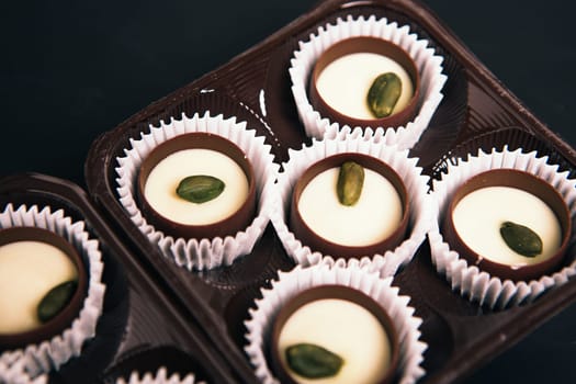 Many chocolate sweets with Pistachio on black background