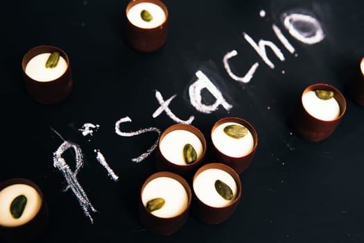 Many chocolate sweets with Pistachio on black background