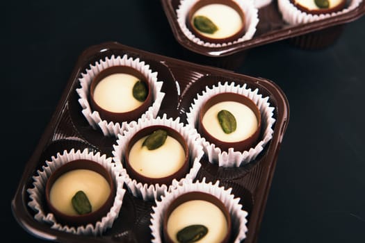 Many chocolate sweets with Pistachio on black background