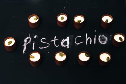 Many chocolate sweets with Pistachio on black background