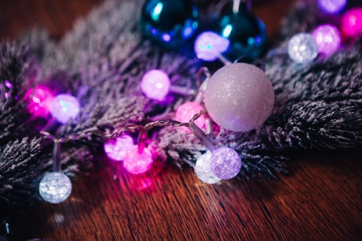 violet blue and white christmas balls on dark wooden background
