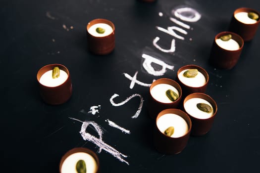 Many chocolate sweets with Pistachio on black background