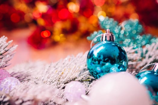 Spruce branches in the snow, and blue balls wooden background