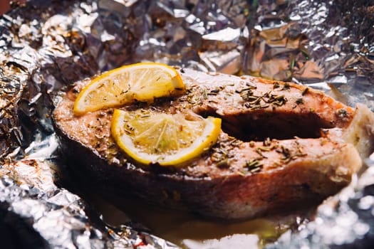 fish steak baked with lemon and herbs in foil