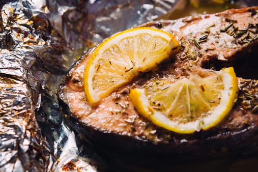 fish steak baked with lemon and herbs in foil