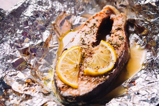 fish steak baked with lemon and herbs in foil