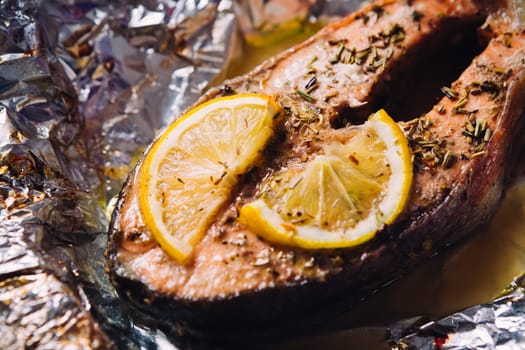 fish steak baked with lemon and herbs in foil