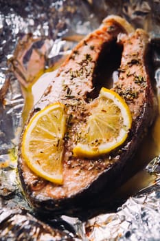 fish steak baked with lemon and herbs in foil