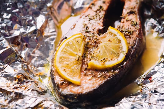 fish steak baked with lemon and herbs in foil