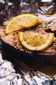 fish steak baked with lemon and herbs in foil