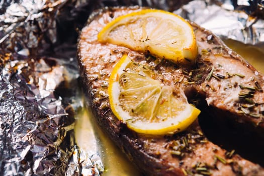 fish steak baked with lemon and herbs in foil