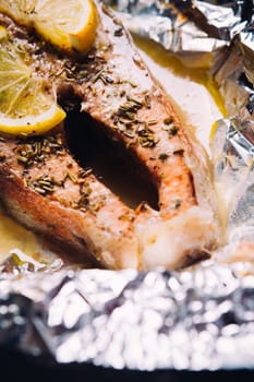 fish steak baked with lemon and herbs in foil