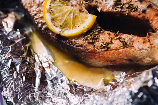 fish steak baked with lemon and herbs in foil