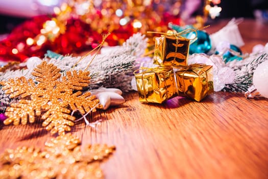 Spruce branches in the snow gold and white christmas decoration on wooden background