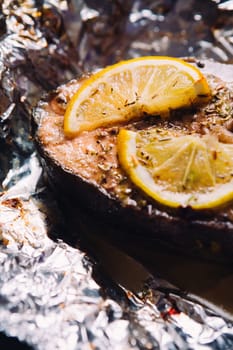 fish steak baked with lemon and herbs in foil