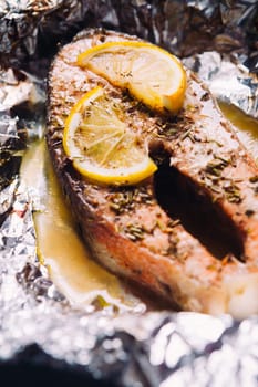 fish steak baked with lemon and herbs in foil